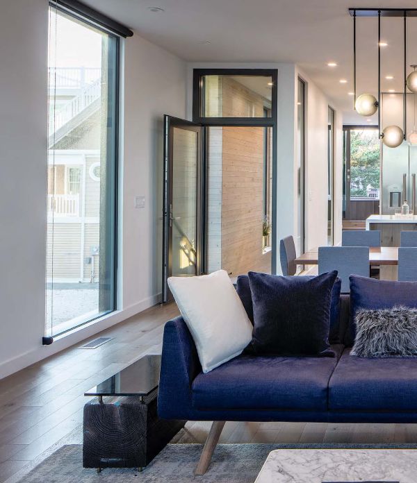 Book cover of Beautiful Beach Houses: Living in Stunning Coastal Escapes, with a bright interior of beach house with sea view through windows. Published by Images Publishing.