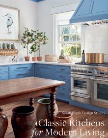 Kitchen interior space, blue fittings, wooden table, copper pan on hob, Classic Kitchens for Modern Living in white font to lower right corner