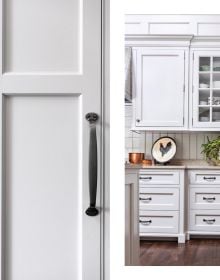 Kitchen interior space, blue fittings, wooden table, copper pan on hob, Classic Kitchens for Modern Living in white font to lower right corner