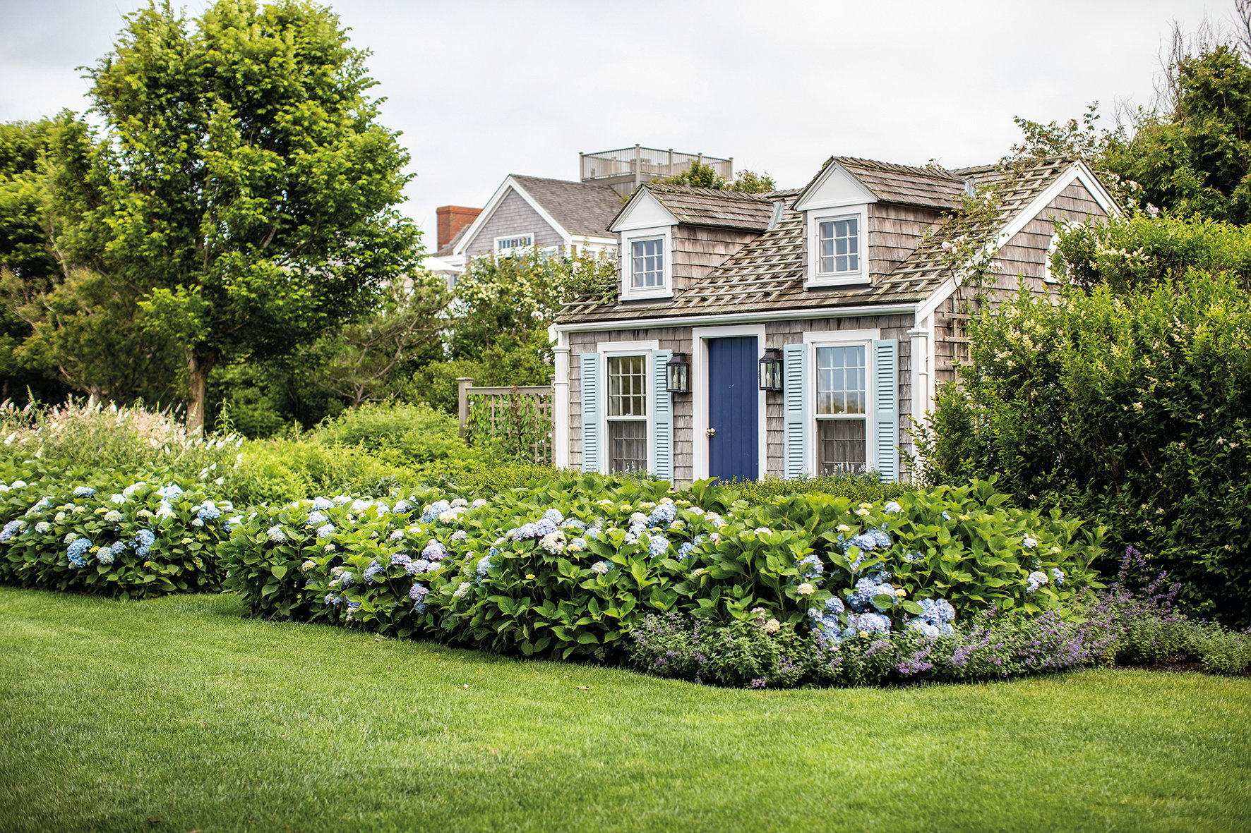 Blue cover with orange silhouette of grass, NANTUCKET Classic American style 30 miles out to sea in white font above.