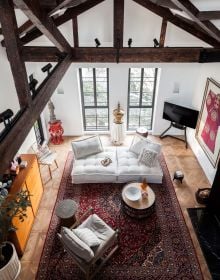 Book cover of Residences Reimagined: Successful Renovation and Expansion of Old Homes, featuring an interior room with exposed brickwork, beamed ceiling, and an armchair on white tiled floor. Published by Images Publishing.