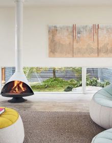 Book cover of Artists' Homes Designing Spaces for Living a Creative Life, with a bright open interior art studio space with artist sitting at painting easel. Published by Images Publishing.