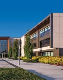 Modern architecture structure with black faded sky above, ROBERT L THOMPSON TVA ARCHITECTS in white font above.