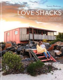 Coastal shack with couple sitting on steps, orange sky above, LOVE SHACKS, in white font above.