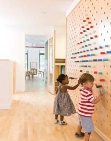 Book cover of Contemporary Creative Spaces for Children, featuring two boys playing on suspended multicoloured webbing. Published by Images Publishing.