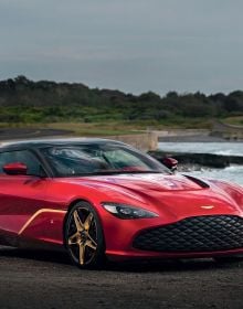 Book cover of Aston Martin: The DB Label: From the DB2 to the DBX, featuring an orange Aston Martin Virage Coupé, with mountain-scape behind. Published by Images Publishing.