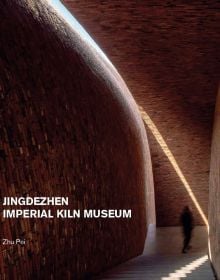 Book cover of Jingdezhen Imperial Kiln Museum, with interior wall and staircase of the museum, with a visitor walking down corridor. Published by Images Publishing.