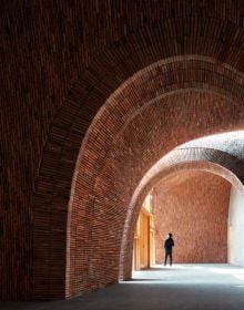 Book cover of Jingdezhen Imperial Kiln Museum, with interior wall and staircase of the museum, with a visitor walking down corridor. Published by Images Publishing.