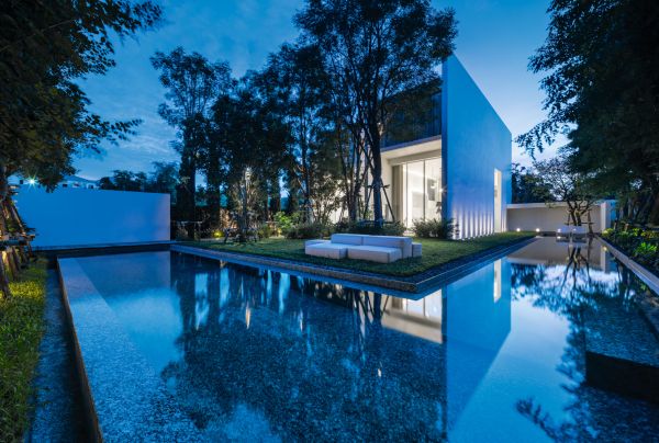 Book cover of TROP terrains + open space: Works 2007–2023, with the top of a building roof, with two spaces holding large trees. Published by Images Publishing.