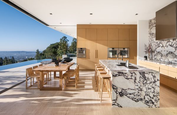 Book cover of Kitchen Conversations: Sharing Secrets to Kitchen Design Success, with the interior of clean, white kitchen with tiled floor and large oven. Published by Images Publishing.