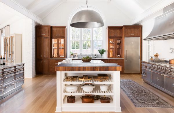 Book cover of Kitchen Conversations: Sharing Secrets to Kitchen Design Success, with the interior of clean, white kitchen with tiled floor and large oven. Published by Images Publishing.