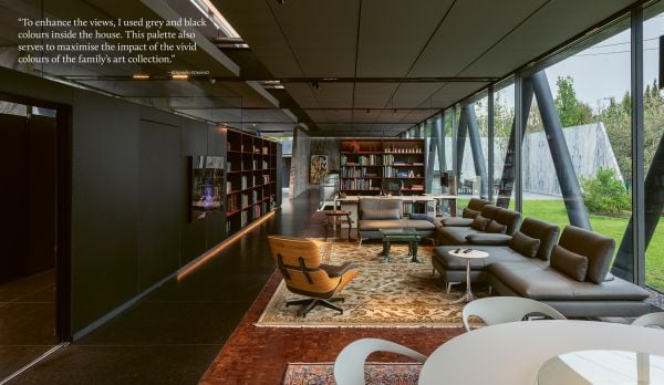 Book cover of Susan Redman's Modern Homes in Black, with a black wooden lake house in Berlin, surrounded by a garden. Published by Images Publishing.