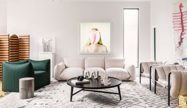 Book cover of Curated Living: Elegant Interiors and Artful Homes, featuring an interior living room with wood table and beige drapes. Published by Images Publishing.