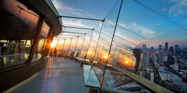 Book cover of New Heights, Transforming Seattle's Iconic Space Needle, with the saucer-shaped top of Seattle Space needle with yellow sunset behind. Published by Images Publishing.
