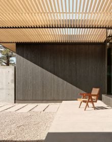 Book cover of Aidlin Darling Design's High Desert Retreat, with large rocks and roof structure behind. Published by Images Publishing.