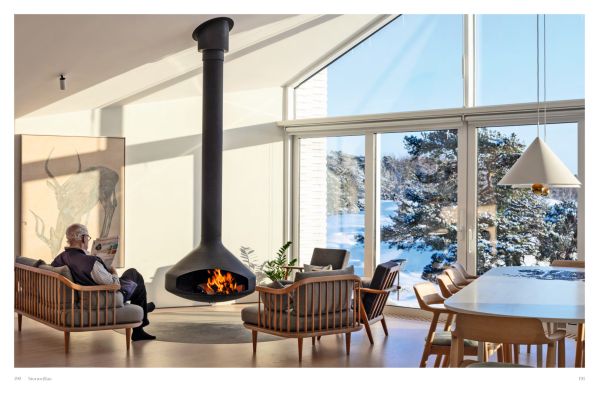 Book cover of Winter Homes: Stylish Living for Cool Climates, with a cabin obscured by snow-covered forest trees. Published by Images Publishing.