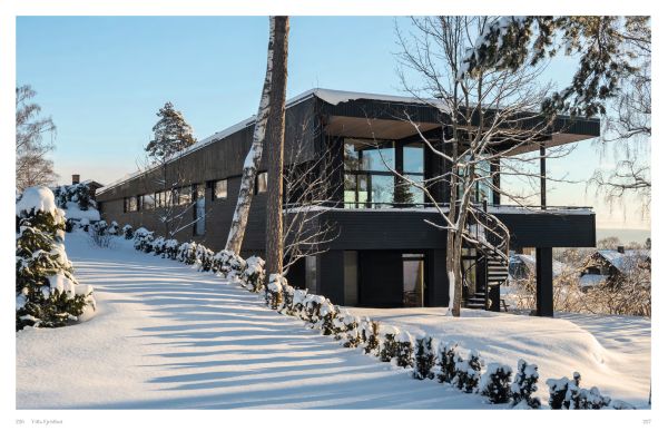 Book cover of Winter Homes: Stylish Living for Cool Climates, with a cabin obscured by snow-covered forest trees. Published by Images Publishing.