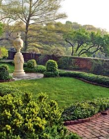 Book cover of Women Garden Designers: From 1900 to the Present, featuring Jinny Blom’s charity inspired garden design, with large stone disc surrounded by green plants. Published by ACC Art Books.