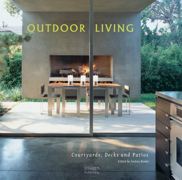 Book cover of Outdoor Living: Courtyards, Decks and Patios featuring a garden patio area with fireplace, table and chairs, and oven. Published by Images Publishing.