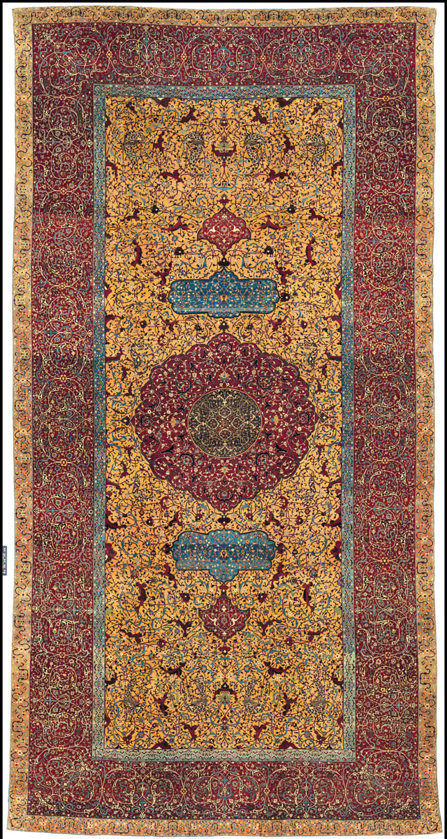 Red and blue medallion design carpet design, on cover of 'The Persian Carpet Tradition, Six Centuries of Design Evolution', by Hali Publications.