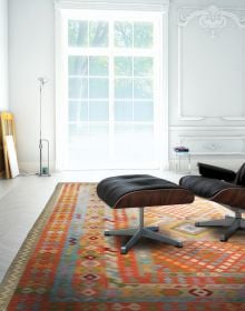 Montage of colourful pattered rugs, on white cover of 'The Handmade Carpet, A Comprehensive Guide to Contemporary Rugs', by Hali Publications.