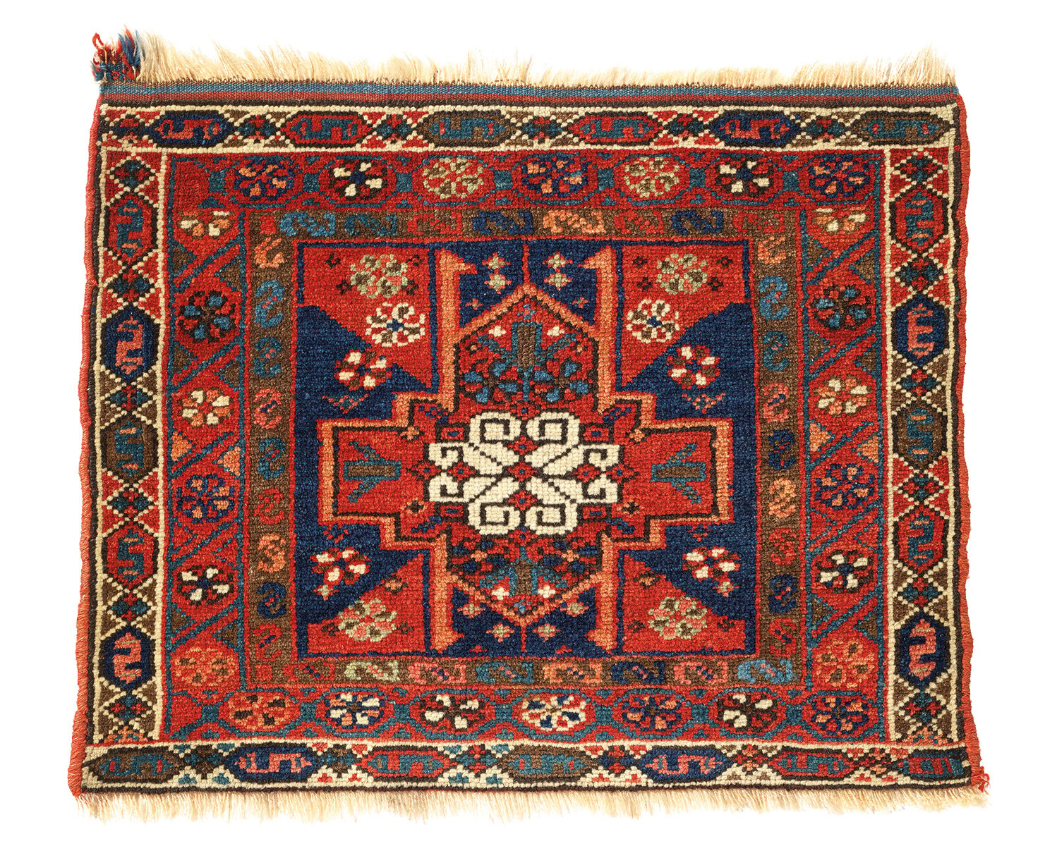 Orange rug with four animals and diamond patterns on cover of 'Nomadic Visions', by Hali Publications.