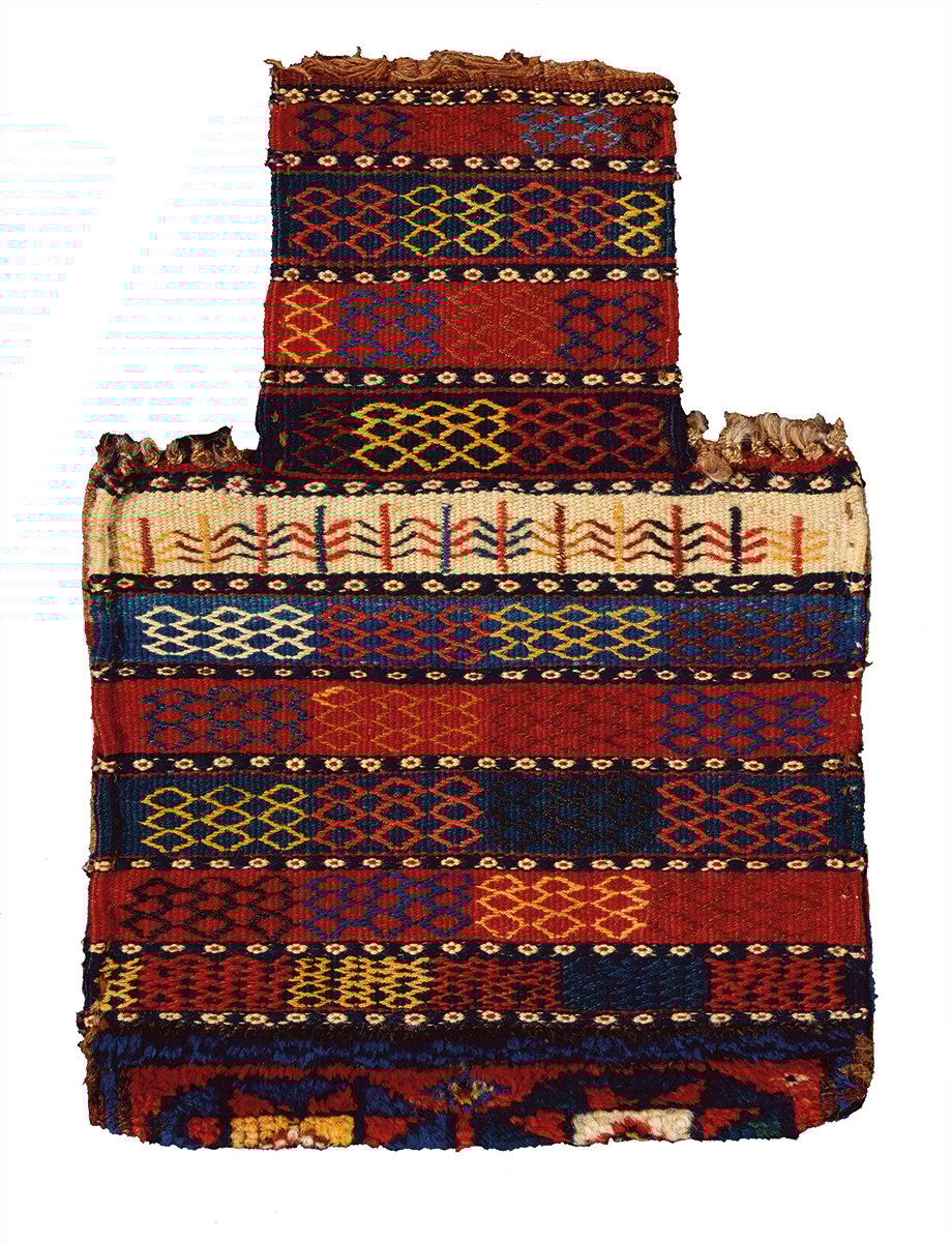 Orange rug with four animals and diamond patterns on cover of 'Nomadic Visions', by Hali Publications.
