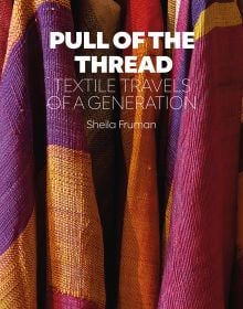 Book cover of Sheila Fruman’s Pull of the Thread, Textile Travels of a Generation, with colourful checked fabric in purple, pink and orange. Published by Hali Publications.