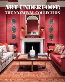 Interior designer Alexa Hampton's living room project, red wallpaper, patterned rug, fireplace, on cover of 'Art Underfoot, The Nazmiyal Collection', by Hali Publications.