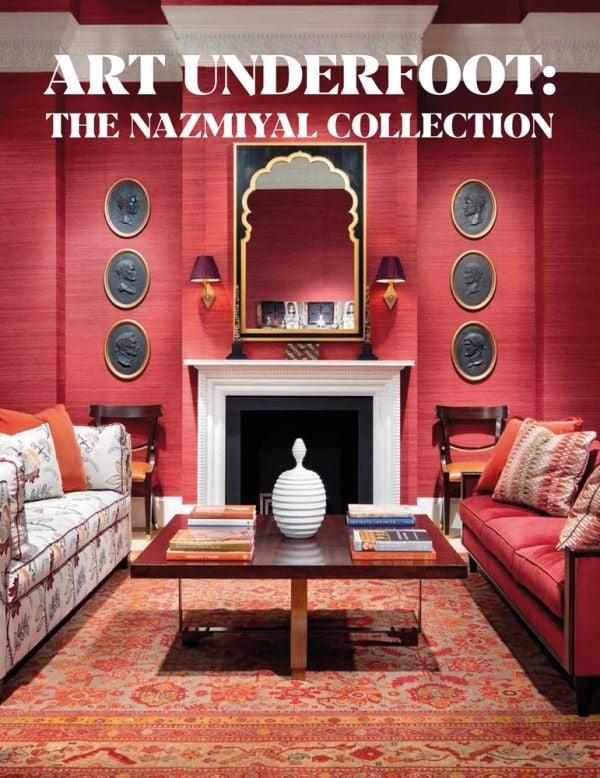 Book cover of Art Underfoot, The Nazmiyal Collection, with interior designer Alexa Hampton's living room project, with red wallpaper, patterned rug, and fireplace. Published by Hali Publications.