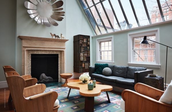 Book cover of Art Underfoot, The Nazmiyal Collection, with interior designer Alexa Hampton's living room project, with red wallpaper, patterned rug, and fireplace. Published by Hali Publications.