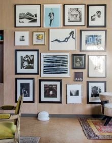 Interior designer Alexa Hampton's living room project, red wallpaper, patterned rug, fireplace, on cover of 'Art Underfoot, The Nazmiyal Collection', by Hali Publications.