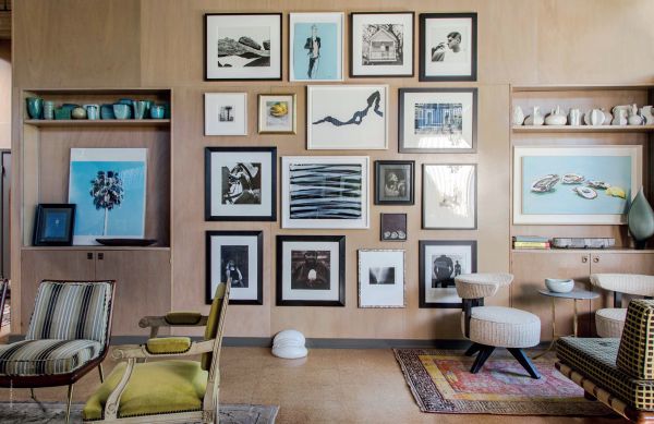 Book cover of Art Underfoot, The Nazmiyal Collection, with interior designer Alexa Hampton's living room project, with red wallpaper, patterned rug, and fireplace. Published by Hali Publications.