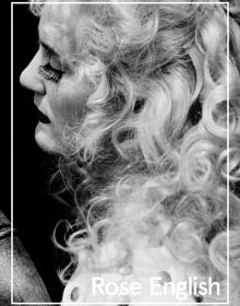 Rose English with blonde curly hair, false eyelashes, 'Rose English', in white font below, by Ridinghouse.