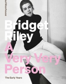 Bridget Riley sitting on a table, 'Bridget Riley: A Very Very Person', in white, and pink font to left side, by Ridinghouse.