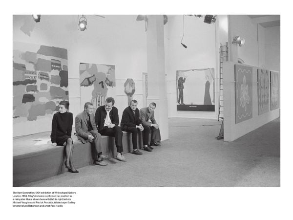Bridget Riley sitting on a table, 'Bridget Riley: A Very Very Person', in white, and pink font to left side, by Ridinghouse.