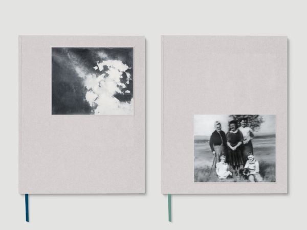 2 cream books, side by side, book mark ribbons poking out below, 2 black and white photos on front of each