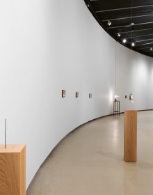 Artist Shilpa Gupta's sound installation exhibition featuring a tall metal spike on wood plinth.