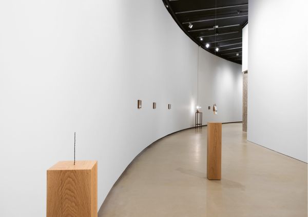 Artist Shilpa Gupta's sound installation exhibition featuring a tall metal spike on wood plinth.