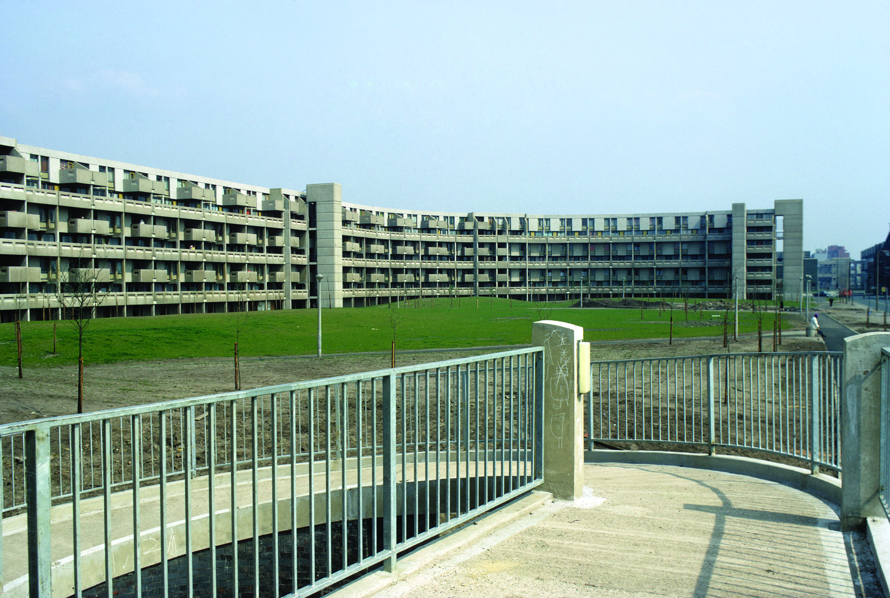 Low angled shot of grey high rise building, 'LOST FUTURES', in white font to yellow cover above.