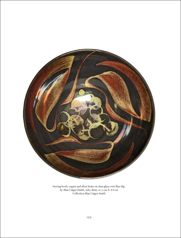 Curved ceramic piece with gold patterns, on blue cover of 'Alan Caiger-Smith and the Legacy of the Aldermaston Pottery', by Ashmolean Museum.