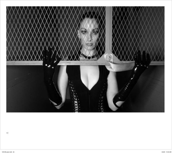 Woman in red suit sitting on Mae West lips sofa, with her red stilettos across a nude woman laying on floor, on cover of 'Alejandra Guerrero - Wicked Women', by Circa Press.