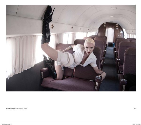 Woman in red suit sitting on Mae West lips sofa, with her red stilettos across a nude woman laying on floor, on cover of 'Alejandra Guerrero - Wicked Women', by Circa Press.