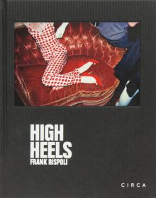 Small landscape photo mounted on black cover of figure lounging on red chaise longue with red stiletto heels and High Heels Frank Rispoli in white font below