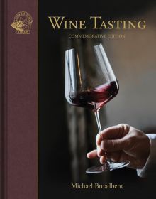 Book cover of Wine Tasting, with a hand gently swirling a glass of red wine. Published by Academie du Vin Library.
