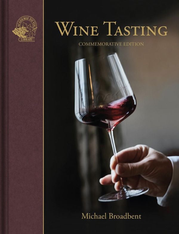 Book cover of Wine Tasting, with a hand gently swirling a glass of red wine. Published by Academie du Vin Library.
