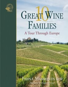 Stunning view of European vineyards with building in distance, on cover of '10 Great Wine Families, A Tour Through Europe' by Academie du Vin Library.