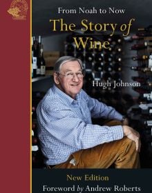 Book cover of The Story of Wine, From Noah to Now The Story of Wine, with Hugh Johnson sitting inside wine storage room. Published by Academie du Vin Library..