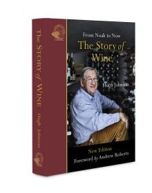 Book cover of The Story of Wine, From Noah to Now The Story of Wine, with Hugh Johnson sitting inside wine storage room. Published by Academie du Vin Library..
