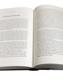 Book cover of The Story of Wine, From Noah to Now The Story of Wine, with Hugh Johnson sitting inside wine storage room. Published by Academie du Vin Library..